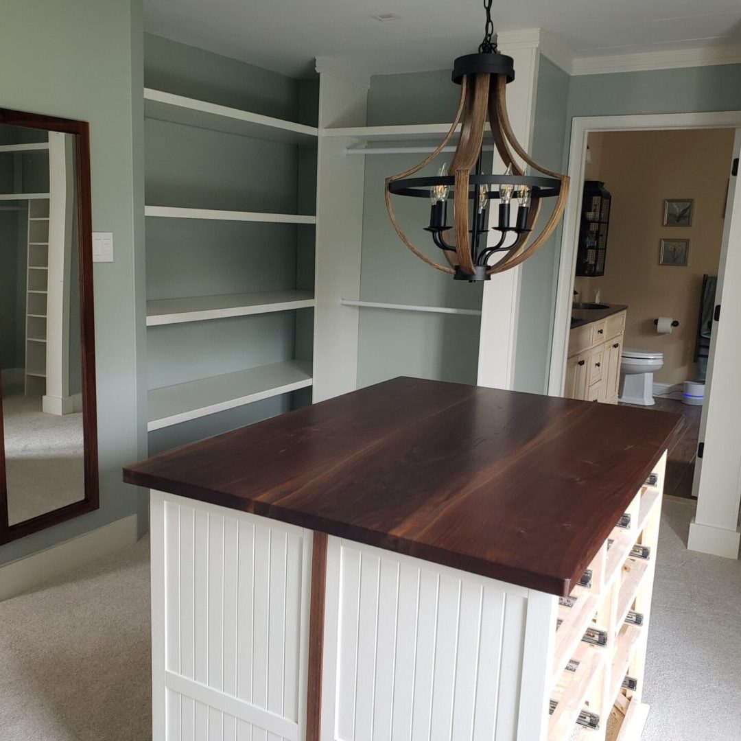 Walk-in closet with island and shelves.