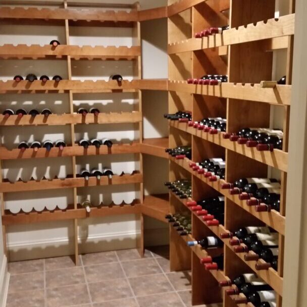 Wine cellar with wooden shelves and bottles.