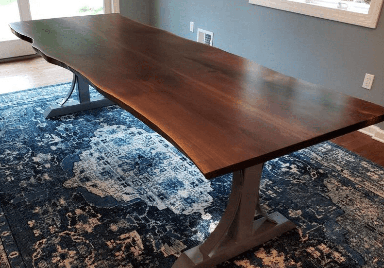 Wooden table on patterned blue rug.